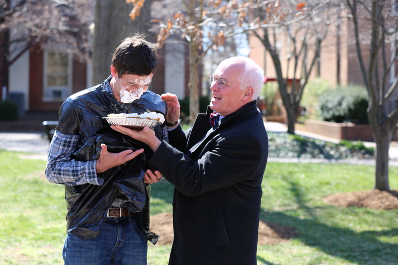 President Maxey throwing a pie in another student's face