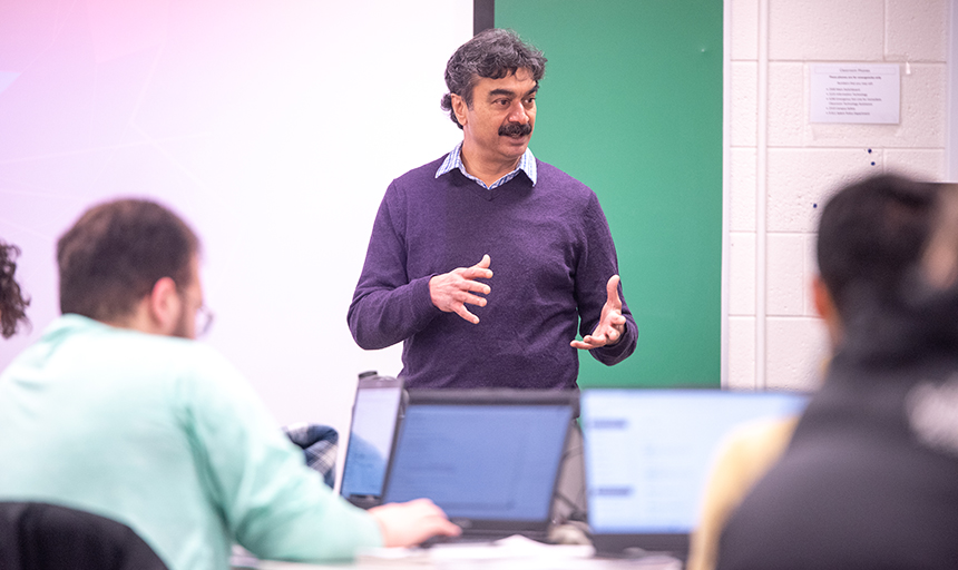 Professor Anil Shende interacts with one of his computer science classes.