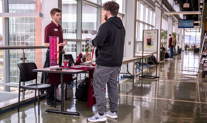 Assistant Director of Admissions Tyler Wertman, who focuses on transfer and graduate recruitment at Roanoke College, chats with a student at Virginia Western Community College.