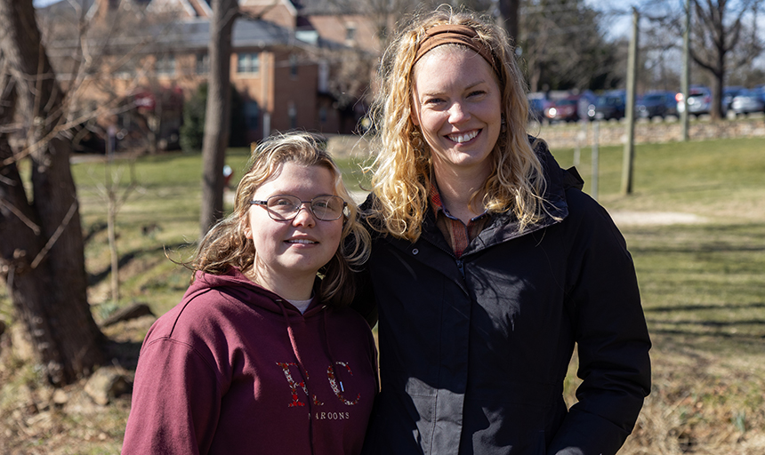 Makenna Keith, in a maroon Roanoke College sweatshirt, and Assistant Professor Chelsea Peters, in a black jacket, stand next to each other for a photo.