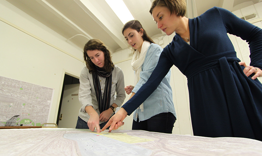 Dr. Liz Ackley and students look at map