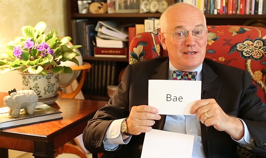 President Maxey holding a card that reads "Bae"