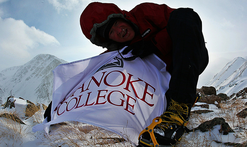 Sean Burch with roanoke college banner