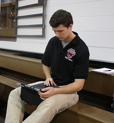 member of the stat crew working on an ipad