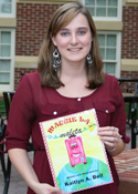 Student holding a children's book