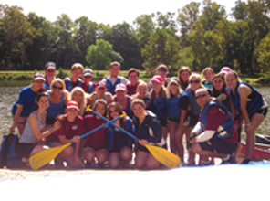 students posing for a group photo after kayaking