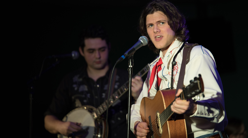 daniel ayers playing the guitar and singing