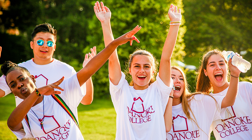 students raising their hands in excitement