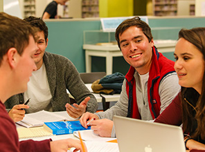 RC student, Ryan collaberating with his group on a project in Fintel Library