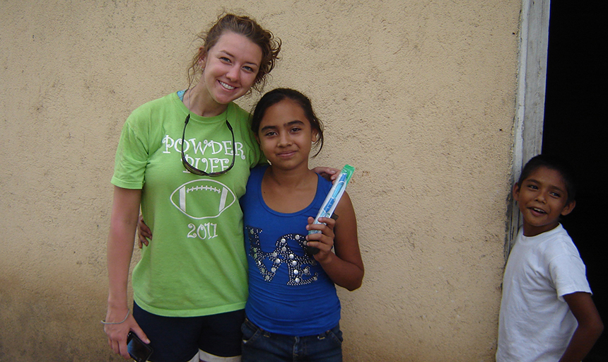 Student posing with a young girl from Nicaragua