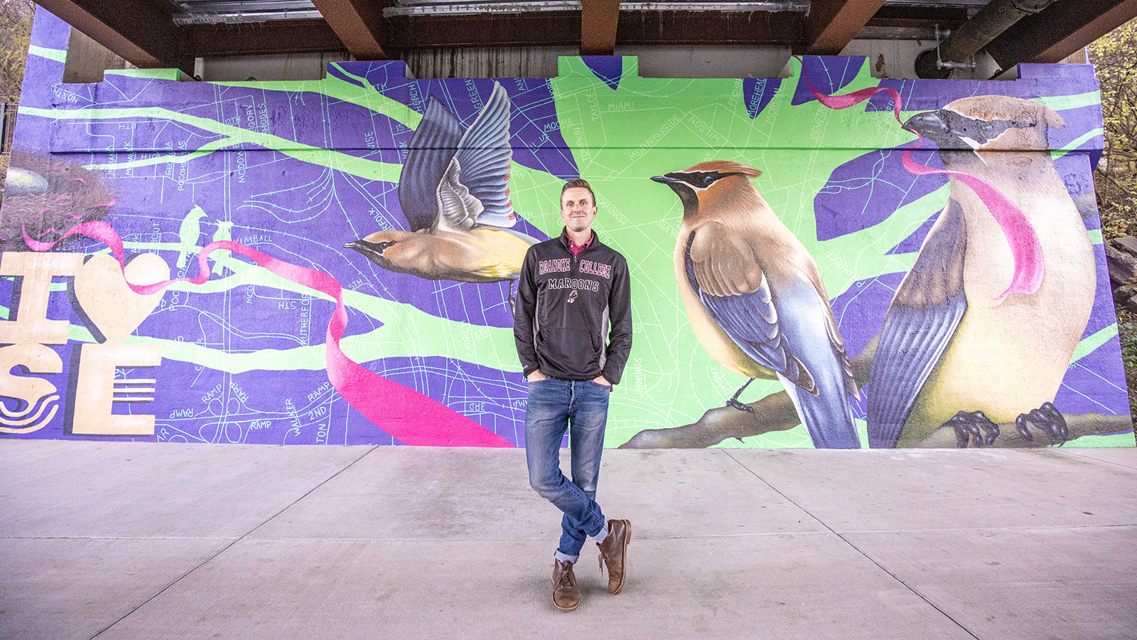 Jon Murrill '09 in front of one of his Roanoke City murals