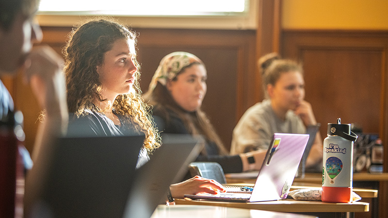 students in class with laptops
