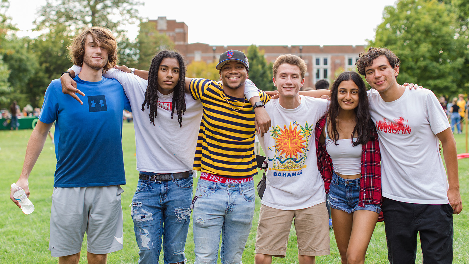 A group of students poses for a photo on the Back Quad.