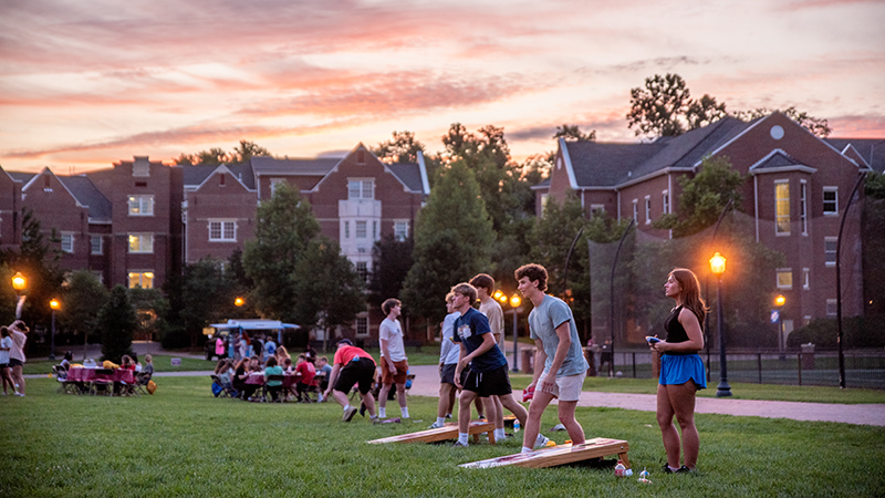 Students on the MAQ with a sunset behind them