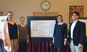 students presenting research poster