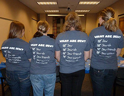 Members of RC Hillel showing off the backs of their shirts