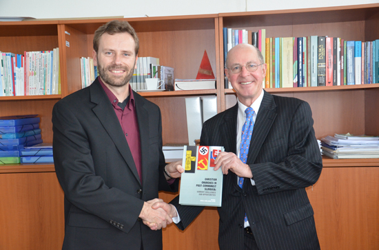 Professor Valco gives a book to the U.S. ambassador to the Slovak Republic, Theodore Sedgwick