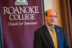 Jonathan Reckford in front of a Roanoke College Banner