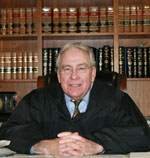 Judge Humes Franklin, Jr. in front of a bookshelf