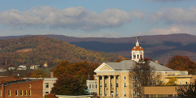 the top of west hall and the mountains behind it