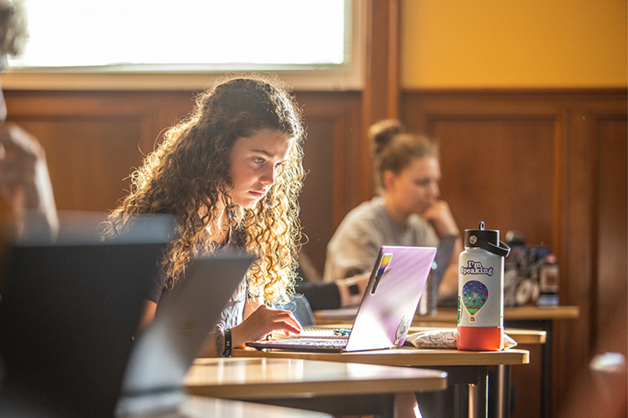 student in public policy class on laptop