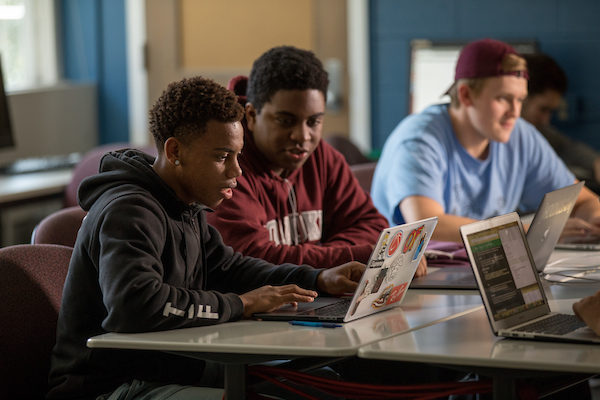 Students looking at a laptop