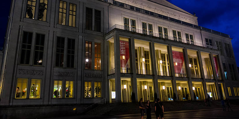A large building in Leipzig lit up at night