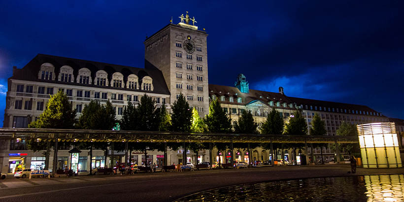 A large building in Leipzig lit up at night