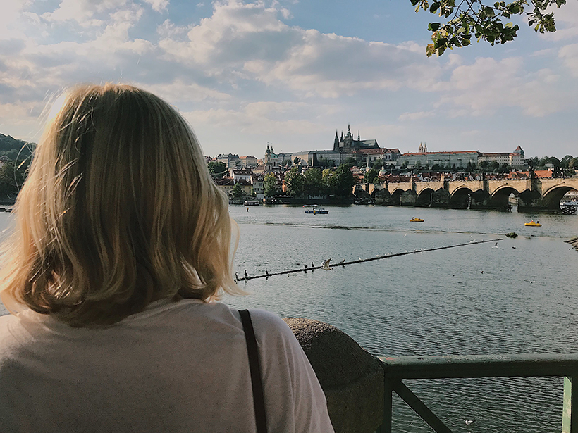 Student standing on the street in Germany facing a bridge