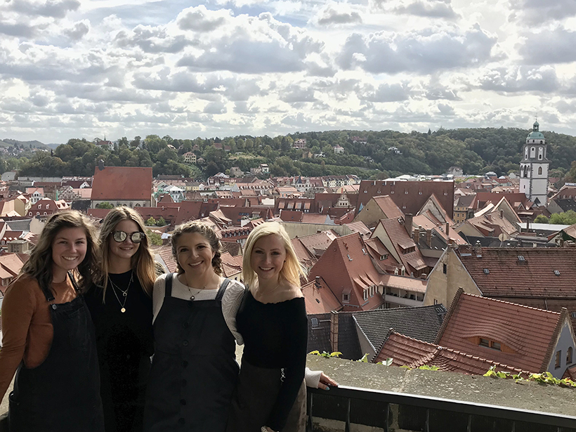 Selfie of students with a city in the background