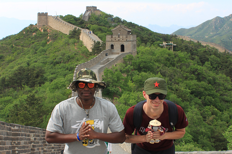 Two students bow on the Great Wall of China