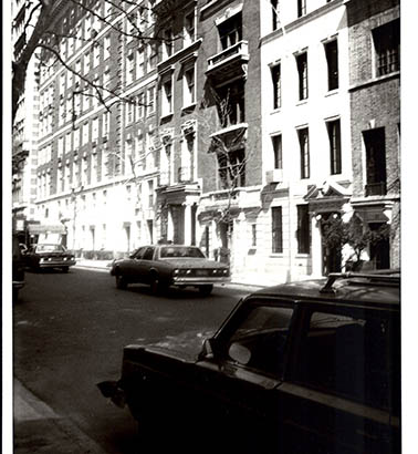 a black and white photo of a busy street in a city