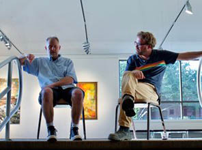 Steve Keene and Steve West sitting in chairs at the top of the stairs