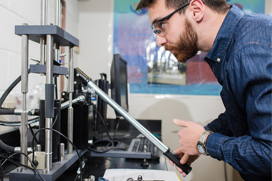 Student working with engineering lab equipment