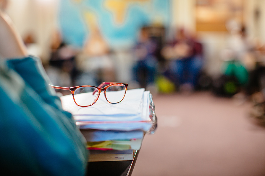 stack of books with a pair of glasses on top