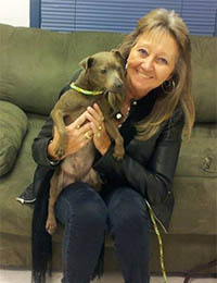 Photo of Teresa Easterling with a dog in her lap