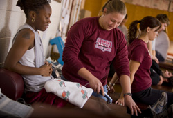 student helping another injured student