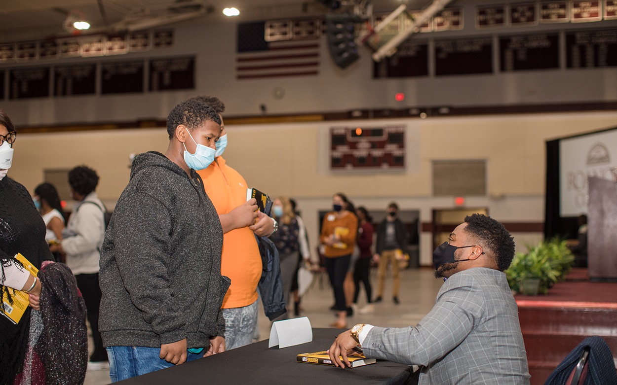 student getting a book signed by fleming