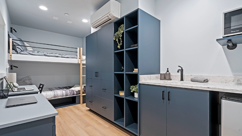 A photo of a bright dorm room outfitted with new furniture