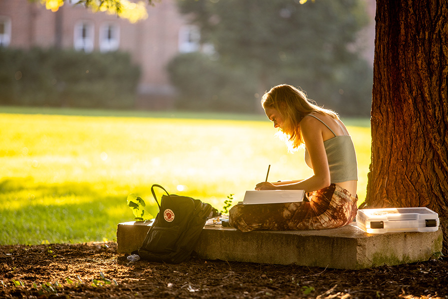 student studying on the back quad