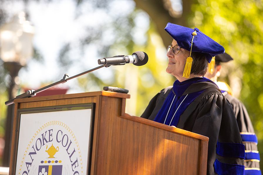 Dr. Kathy Wolfe speaking at a podium