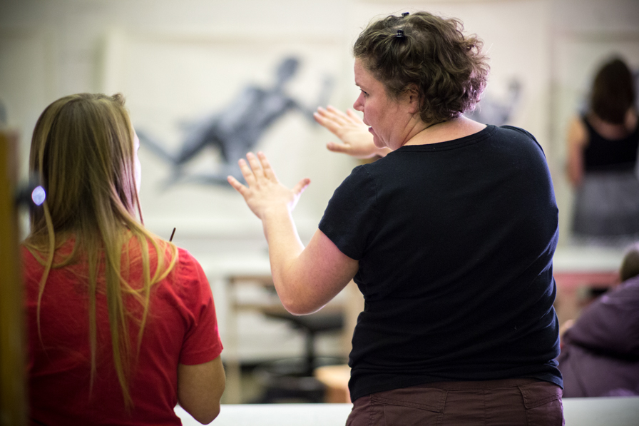 Professor talking to a student about art