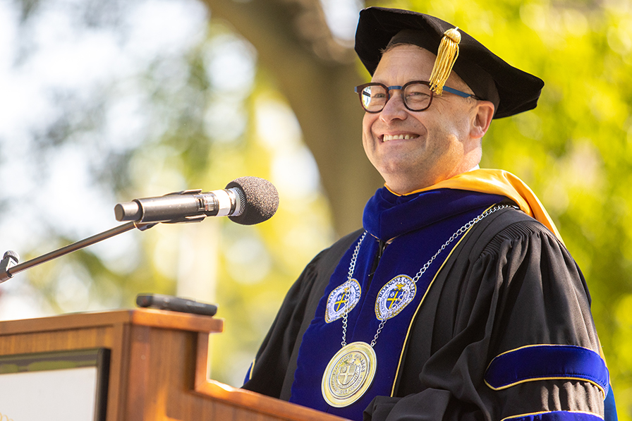 President Frank Shushok at podium at Commencement