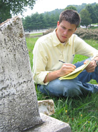 student observing a headstone