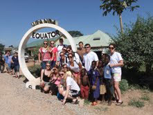 group of students at the equator marker in uganda