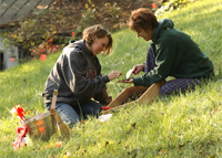 Student and professor sifting through dirt