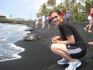 student on the beach with a turtle