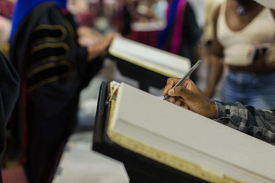 student signing the book