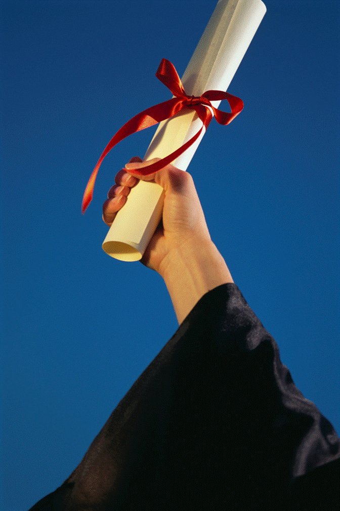 student holding up a diploma