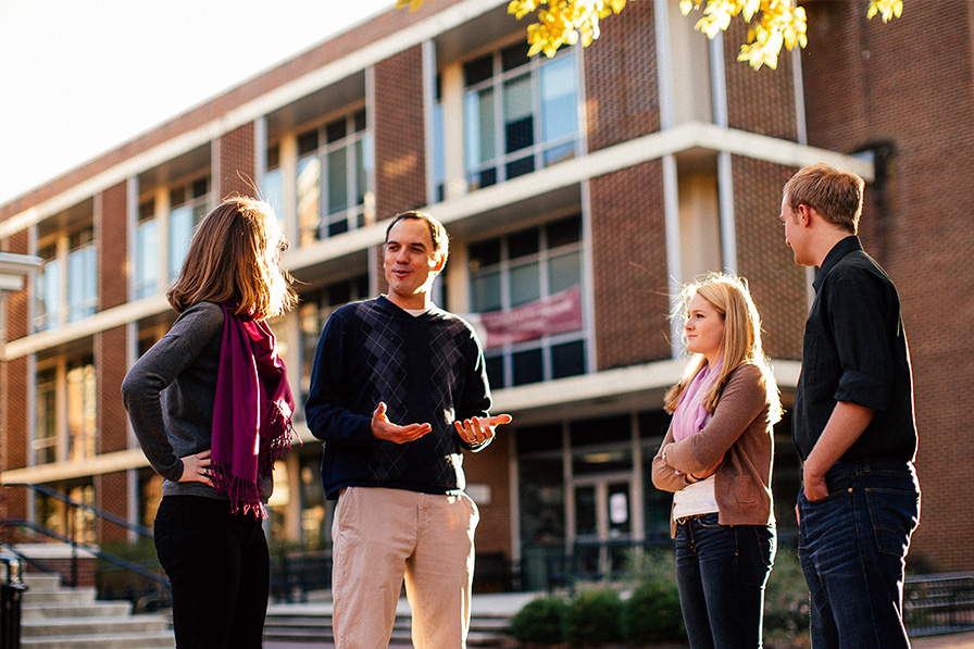 professors and students talking in the plaza of the science complex